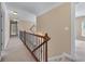 Upstairs hallway featuring neutral walls, plush carpeting, and decorative wall art accents at 871 Windsor Creek Dr, Grayson, GA 30017