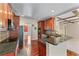 Well-equipped kitchen with granite countertops, wooden cabinetry, and stainless steel appliances at 871 Windsor Creek Dr, Grayson, GA 30017