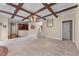 Open-concept living room with coffered ceiling, staircase, and connections to kitchen and dining areas at 871 Windsor Creek Dr, Grayson, GA 30017