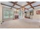 Bright living room with fireplace, glass patio doors and coffered ceiling with wooden beams at 871 Windsor Creek Dr, Grayson, GA 30017