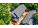 Aerial view of a blue home, with a deck, surrounded by green trees at 1454 Rome Nw Dr, Atlanta, GA 30314