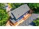 Blue home aerial view surrounded by trees, deck, with a dark gray roof at 1454 Rome Nw Dr, Atlanta, GA 30314
