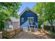 Backyard view of blue house with wooden fence surrounded by mature trees at 1454 Rome Nw Dr, Atlanta, GA 30314