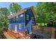 Exterior view of a modern blue house with a wooden deck and fenced yard at 1454 Rome Nw Dr, Atlanta, GA 30314