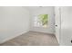 This bedroom features neutral carpet, natural light from the window and a convenient closet at 1454 Rome Nw Dr, Atlanta, GA 30314