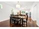 Bright dining area with hardwood floors, contemporary lighting, and an adjacent modern kitchen at 1454 Rome Nw Dr, Atlanta, GA 30314