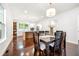 Dining space open to a kitchen with hardwood floors, modern lighting, and ample natural light at 1454 Rome Nw Dr, Atlanta, GA 30314