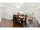 Open-concept living space showcasing a dining area with views to the living room and hardwood flooring at 1454 Rome Nw Dr, Atlanta, GA 30314