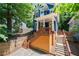Charming two-story blue home surrounded by mature trees and beautiful landscaping at 1454 Rome Nw Dr, Atlanta, GA 30314