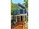 Beautiful blue home showcases a sunburst gable design and welcoming porch entrance at 1454 Rome Nw Dr, Atlanta, GA 30314