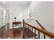 Hallway featuring hardwood floors, a window, and a decorative table with a small plant at 1454 Rome Nw Dr, Atlanta, GA 30314
