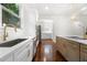 Modern kitchen with stainless steel appliances, white cabinets, and wood-accented island, offering a sleek design at 1454 Rome Nw Dr, Atlanta, GA 30314