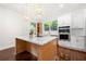 Bright kitchen featuring a large island, stainless steel appliances, and modern pendant lighting at 1454 Rome Nw Dr, Atlanta, GA 30314