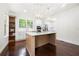 Modern kitchen featuring a large island, stainless steel appliances, and custom white cabinetry at 1454 Rome Nw Dr, Atlanta, GA 30314