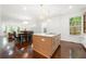 Modern kitchen with open layout, stainless appliances, island, and view to dining and living areas at 1454 Rome Nw Dr, Atlanta, GA 30314