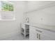 Functional laundry room with white cabinetry, marble countertop and a sink at 1454 Rome Nw Dr, Atlanta, GA 30314