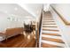 Open-concept space with hardwood floors, comfortable seating, dining area, and staircase at 1454 Rome Nw Dr, Atlanta, GA 30314
