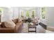 Inviting living room featuring bay windows, comfortable seating, and hardwood flooring throughout at 1454 Rome Nw Dr, Atlanta, GA 30314