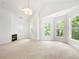 Large and bright main bedroom featuring a cozy fireplace and neutral carpeting at 1454 Rome Nw Dr, Atlanta, GA 30314