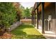 Backyard showcasing a well-manicured lawn, stone retaining wall, and outdoor seating area with a patio at 2469 River Oak Dr, Decatur, GA 30033