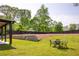 Spacious backyard featuring a manicured lawn, stone retaining wall, and outdoor seating area for entertaining at 2469 River Oak Dr, Decatur, GA 30033