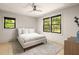 Bright bedroom with a bed, ceiling fan, and large windows that provide ample natural light and outdoor views at 2469 River Oak Dr, Decatur, GA 30033