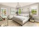 Spacious bedroom with large bed, stylish lighting, and sitting area near the window at 2469 River Oak Dr, Decatur, GA 30033