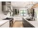 Bright kitchen with stainless steel appliances, white cabinets, marble counters, and a modern island at 2469 River Oak Dr, Decatur, GA 30033