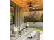 Covered outdoor seating with wood ceiling, ceiling fan, and table with candles on a covered patio at 2469 River Oak Dr, Decatur, GA 30033