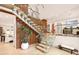 Bright foyer featuring a modern glass and wood staircase with a large potted plant at 2469 River Oak Dr, Decatur, GA 30033