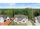 Gorgeous aerial view of new construction property with wooded backdrop, expansive lawn and long driveway at 6750 Pannell Rd, Buford, GA 30518