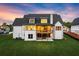 Back exterior of house featuring lawn, a deck, and an outdoor patio space at 6750 Pannell Rd, Buford, GA 30518