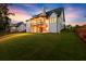 Expansive backyard of a modern home with a covered patio and lush green lawn, perfect for outdoor enjoyment at 6750 Pannell Rd, Buford, GA 30518