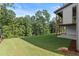 Expansive backyard with lush green lawn and mature trees surrounding the perimeter, providing privacy at 6750 Pannell Rd, Buford, GA 30518