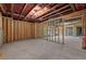 Unfinished basement with exposed framing, offering potential for customization and ample space at 6750 Pannell Rd, Buford, GA 30518
