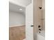 A full bathroom features a shower and tub with light stone textured tile surround at 6750 Pannell Rd, Buford, GA 30518