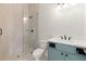 Bathroom featuring a walk-in shower, blue vanity, and sleek fixtures at 6750 Pannell Rd, Buford, GA 30518