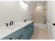 A bathroom features a white countertop, blue vanity, with a shower and tub at 6750 Pannell Rd, Buford, GA 30518