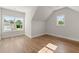 A bright room features hardwood floors, and a large window with backyard views at 6750 Pannell Rd, Buford, GA 30518