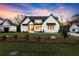 Charming exterior of a newly constructed home with manicured lawn, stone accents, and classic architectural details at 6750 Pannell Rd, Buford, GA 30518