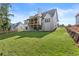 Rear exterior view of a home with a spacious yard and an inviting outdoor living space at 6750 Pannell Rd, Buford, GA 30518