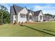 Charming home exterior featuring a well-kept lawn and a mix of brick and siding at 6750 Pannell Rd, Buford, GA 30518