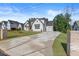Front exterior of a modern home with a long driveway, well-manicured lawn, and beautiful landscaping at 6750 Pannell Rd, Buford, GA 30518