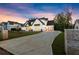 Beautiful new construction home with a brick driveway, white painted brick exterior and black accents at 6750 Pannell Rd, Buford, GA 30518
