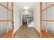 Grand foyer with herringbone wood floors, a staircase and french doors that fill the space with light at 6750 Pannell Rd, Buford, GA 30518