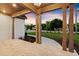 Inviting front porch featuring brick flooring, stylish columns, and a charming view of the landscaped yard at 6750 Pannell Rd, Buford, GA 30518