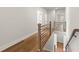 Hallway showcasing hardwood floors, modern railing, and access to various rooms at 6750 Pannell Rd, Buford, GA 30518
