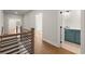Upstairs hallway with hardwood flooring and access to a bathroom at 6750 Pannell Rd, Buford, GA 30518