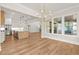 Living room features hardwood floors, large windows, and an open-concept design with kitchen at 6750 Pannell Rd, Buford, GA 30518