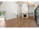 Bright living room with a fireplace, wood floors, and sliding glass doors to the screened porch at 6750 Pannell Rd, Buford, GA 30518